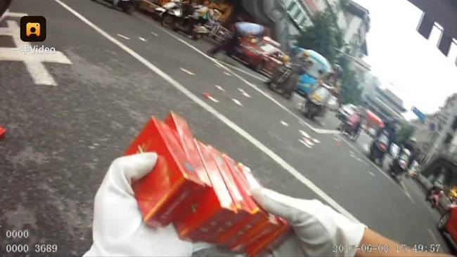 協(xié)警在撿起香煙和錢時說，“我手都放不下了?！? src=